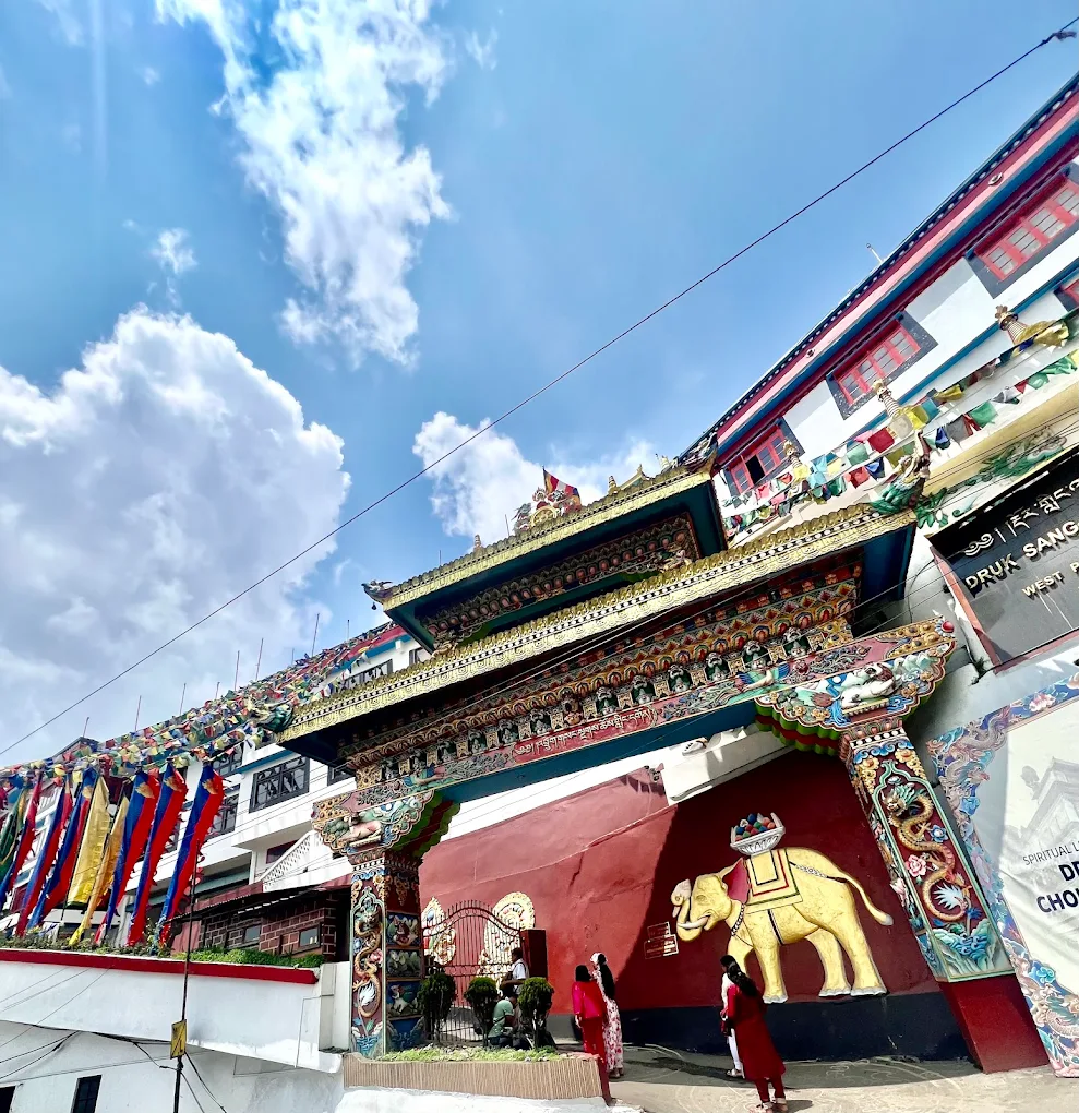 A colourful Himalayan monastery entrance beneath a blue sky
